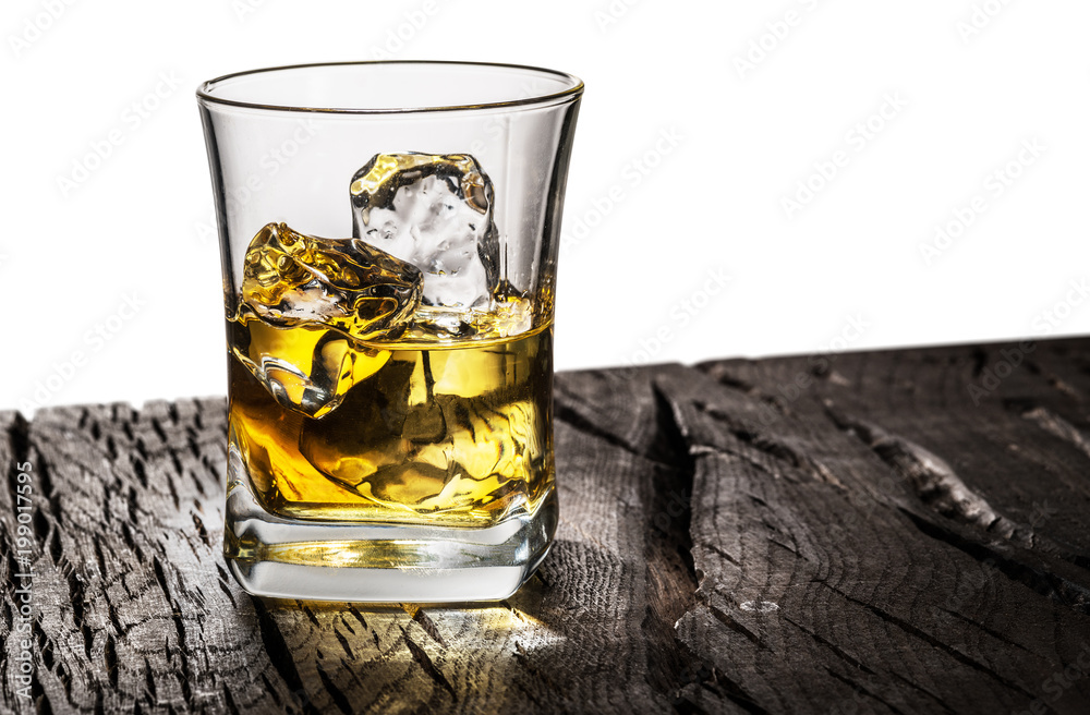 Whiskey glass or glass of whiskey with ice cubes on table at the white background. Whiskey glass or glass of whiskey with ice cubes on table at the white background.
