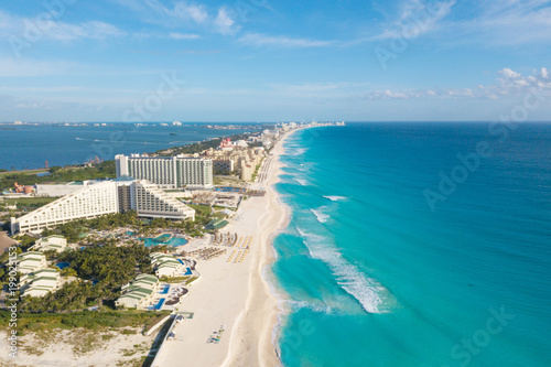 Cancun aerial view. Zona hotelera Cancun beach panorama top view. Caribbean seaside beach with turquoise water and big waves. Yucatan, Quintana Roo, Mexico photo