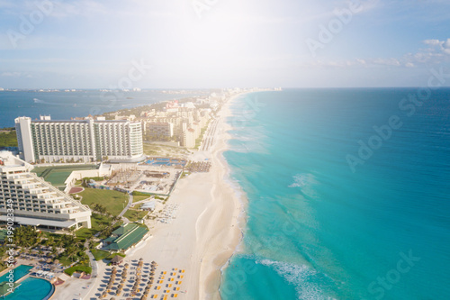 Cancun aerial view. Zona hotelera Cancun beach panorama top view. Caribbean seaside beach with turquoise water and big waves. Yucatan, Quintana Roo, Mexico