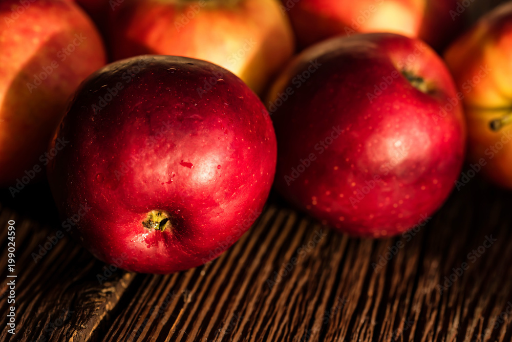 Whole ripe red apples on wooden surface close Whole ripe red apples on wooden surface close