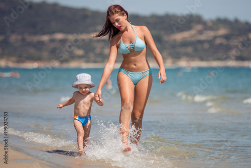 Woman with her son on the beach