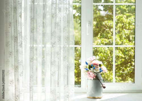 Window with curtains and flowers