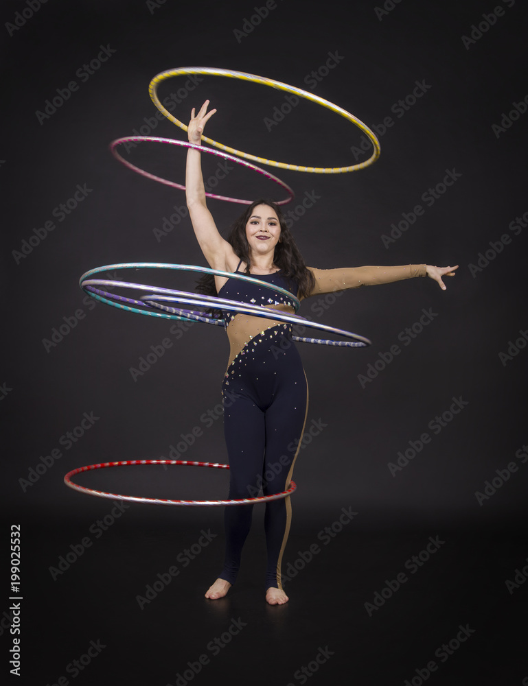Gymnastic exercises with hula Hoop girl performs a circus artist. foto de  Stock | Adobe Stock