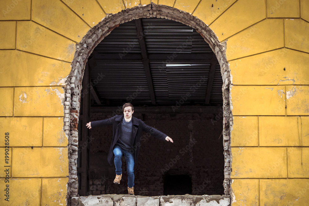 parkour of young man running and jumping out of a window of the buidling parkour of young man running and jumping out of a window of the buidling