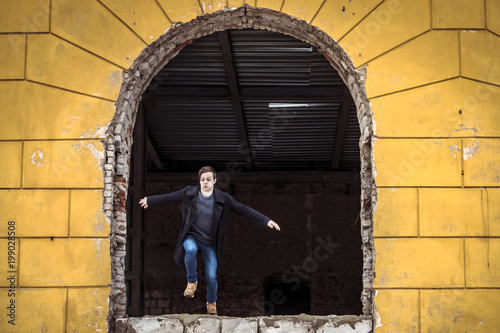 parkour of young man running and jumping out of a window of the buidling