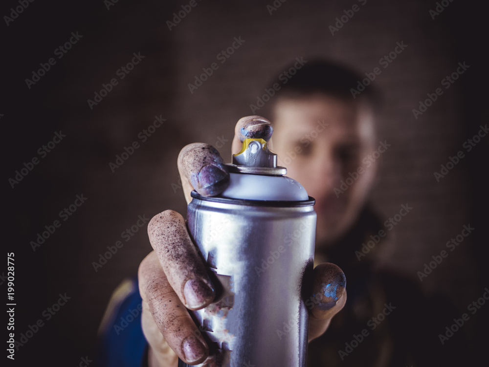 street art artist holding spray paint can in the hand close up Stock Photo  | Adobe Stock