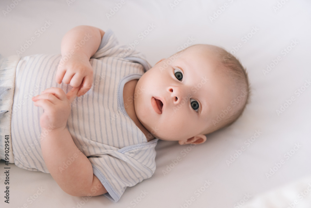 Beautiful newborn baby lying in the crib Beautiful newborn baby lying in the crib
