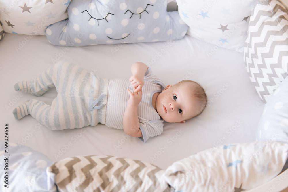 custom made wallpaper toronto digitalBeautiful newborn baby lying in an oval bed with beautiful bumpers in delicate gray, blue, white tones