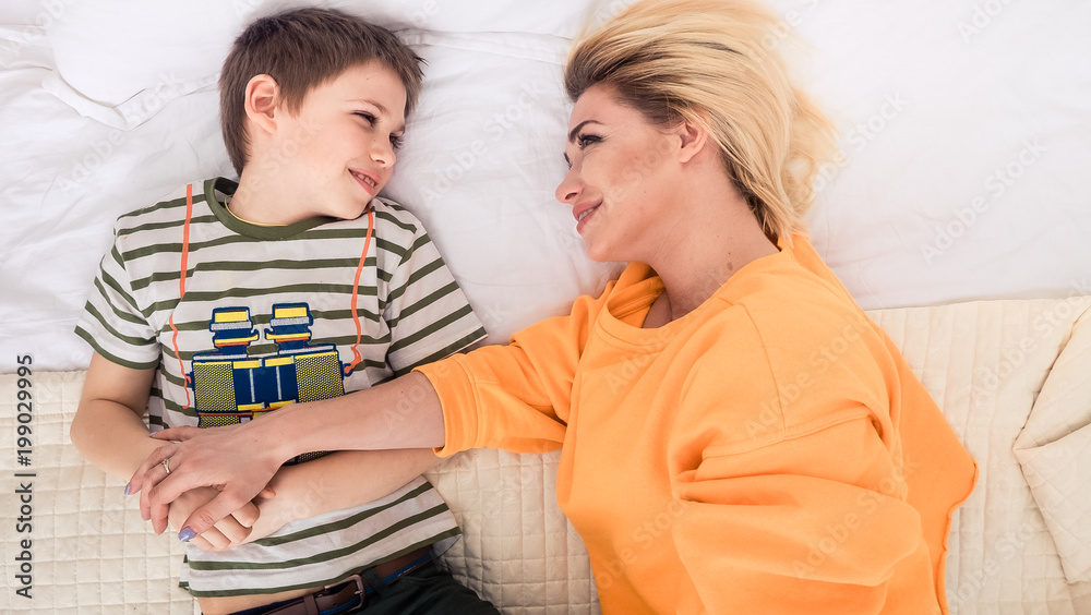Mother with son on bed, mother and son having fun Mother with son on bed, mother and son having fun