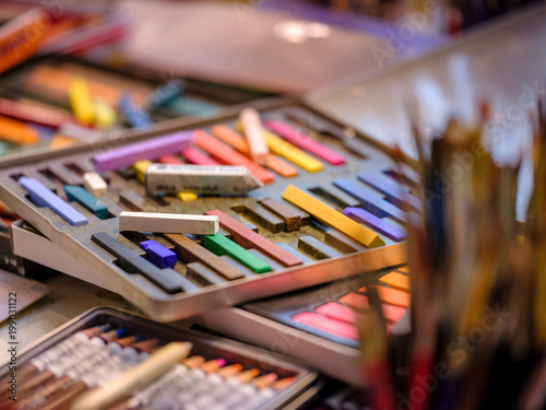 An artist's box of pastels in a studio