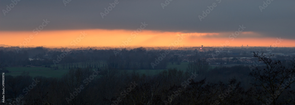 Panoramic sunset landscape of the french countryside in the mist, south of Toulouse in the winter.