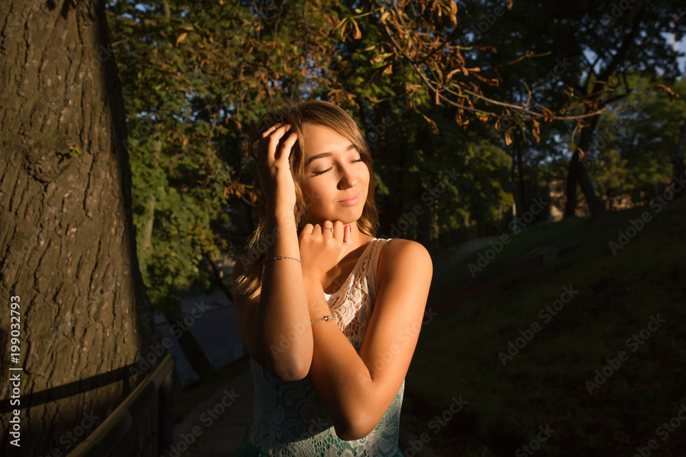Street portrait of young adorable model with closed eyes posing at sunny day Street portrait of young adorable model with closed eyes posing at sunny day
