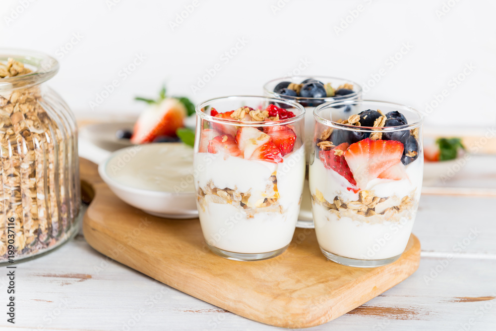 Little Jars with layered dessert from natural yogurt, granola an