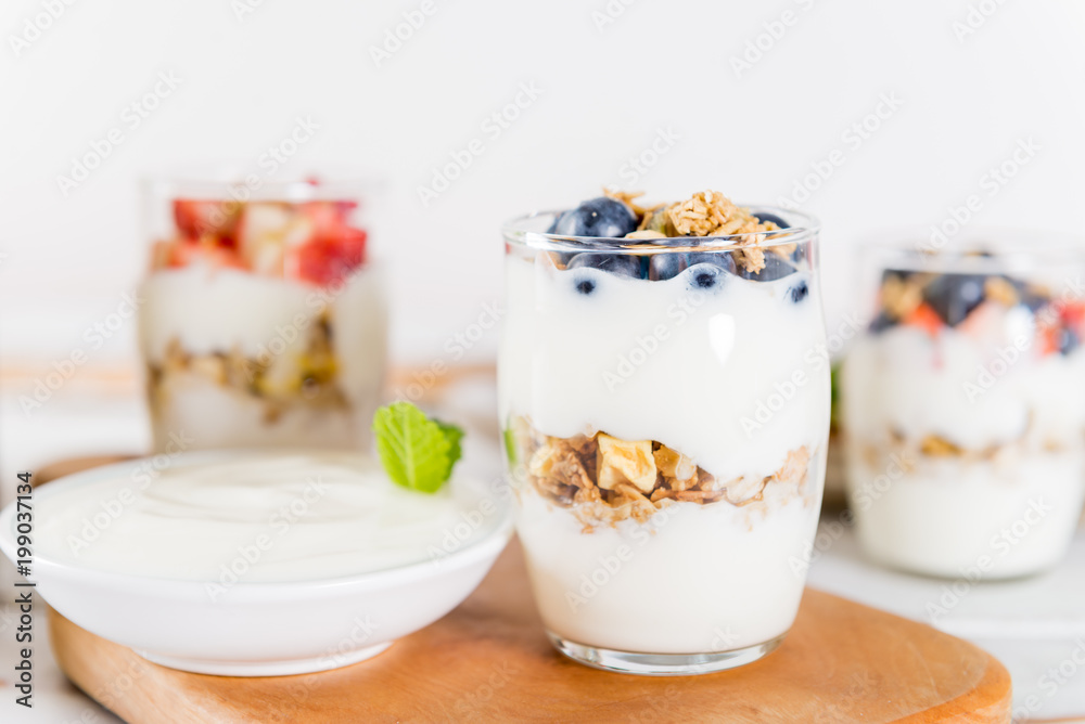 Little Jars with layered dessert from natural yogurt, granola an Little Jars with layered dessert from natural yogurt, granola an