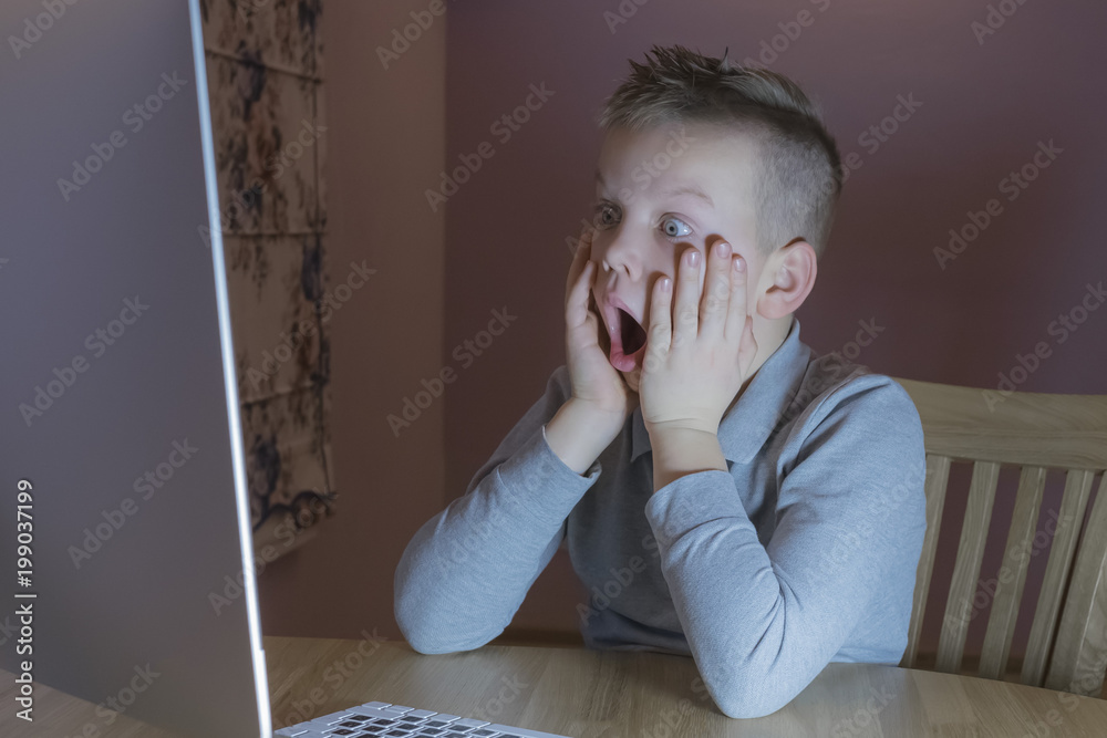 Scared boy using computer Scared boy using computer