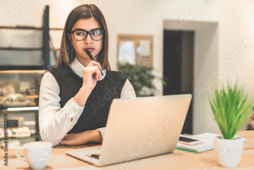 The businesswoman in glasses working with a laptop