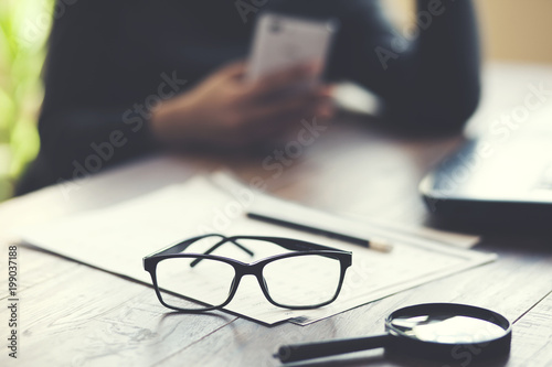 woman hand phone and document on table