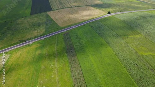 Road among green fields in Cherkessk, Karachaevo-Cherkessia. Beautiful view from above, shooting from a quadopter, 4K photo