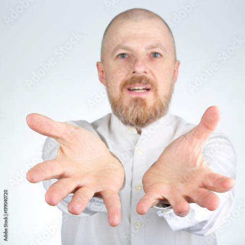Bearded man stretches his arms forward
