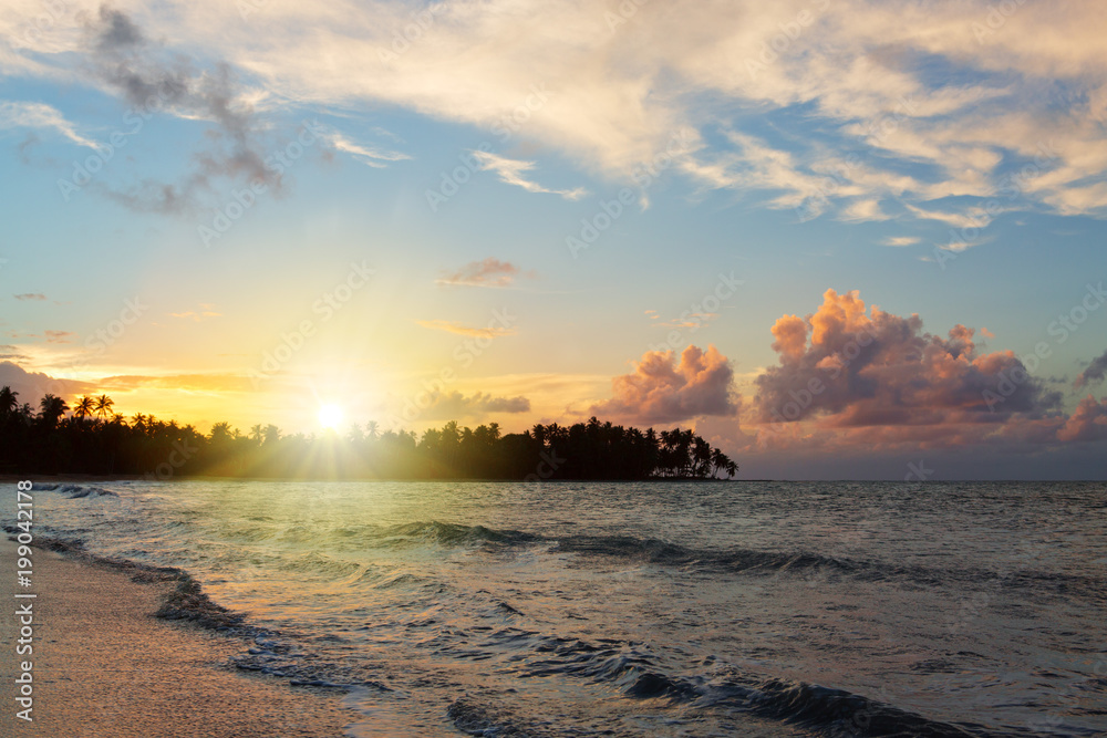 Caribbean sunset on tropical beach.