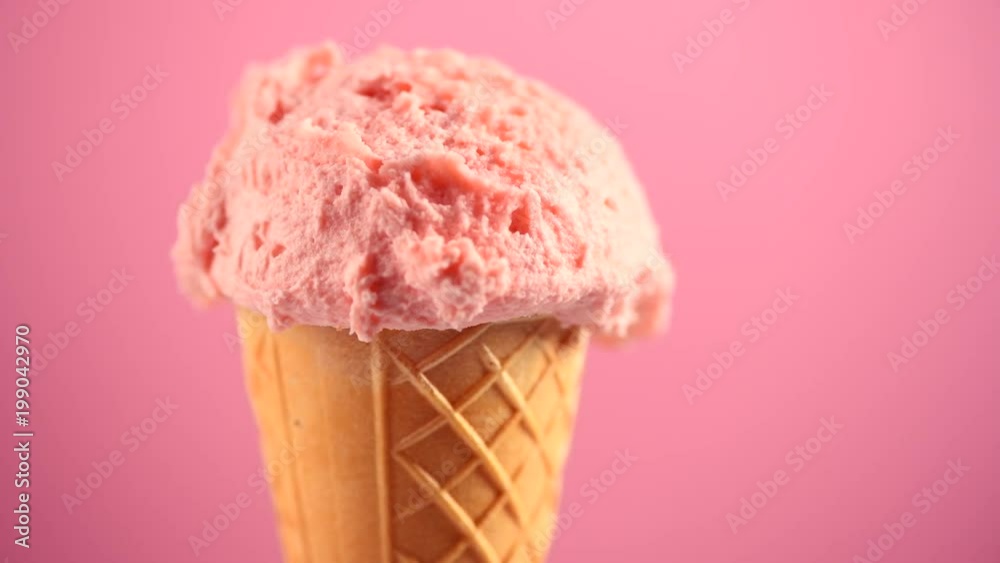 Ice cream. Strawberry or raspberry flavor icecream in waffle cone rotated over pink background. Sweet dessert closeup. 4K UHD video footage. 3840X2160 Ice cream. Strawberry or raspberry flavor icecream in waffle cone rotated over pink background. Sweet dessert closeup. 4K UHD video footage. 3840X2160