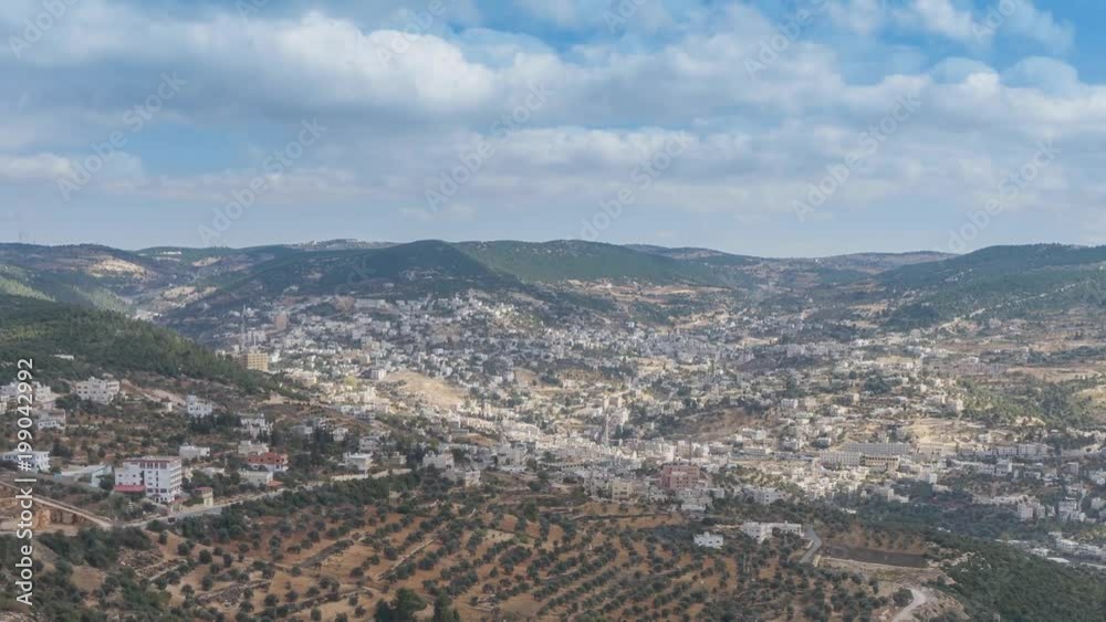 Time lapse of a vally in Jordan with olive orchards below and beautiful clouds forming over head, smooth panning from left to right reveals the entire valley Time lapse of a vally in Jordan with olive orchards below and beautiful clouds forming over head, smooth panning from left to right reveals the entire valley