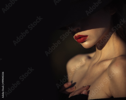 Elegant woman with red lips. elegant woman with naked shoulders on black background, copy space