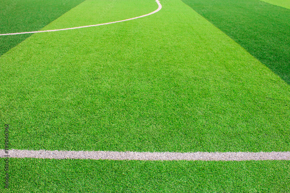 Obraz premium The white Line marking on the artificial green grass soccer field