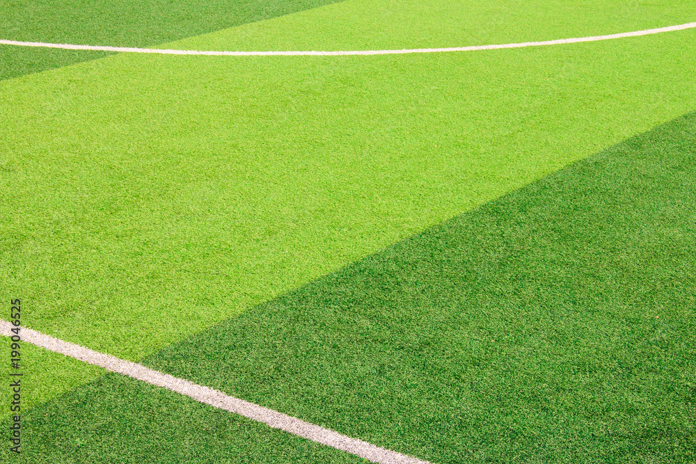 Fototapeta premium The white Line marking on the artificial green grass soccer field