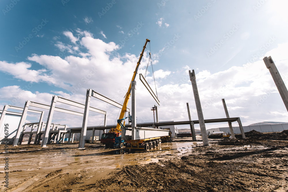 Details of construction site with crane lifting prefabricated concrete framework, unloading and cargo details Details of construction site with crane lifting prefabricated concrete framework, unloading and cargo details