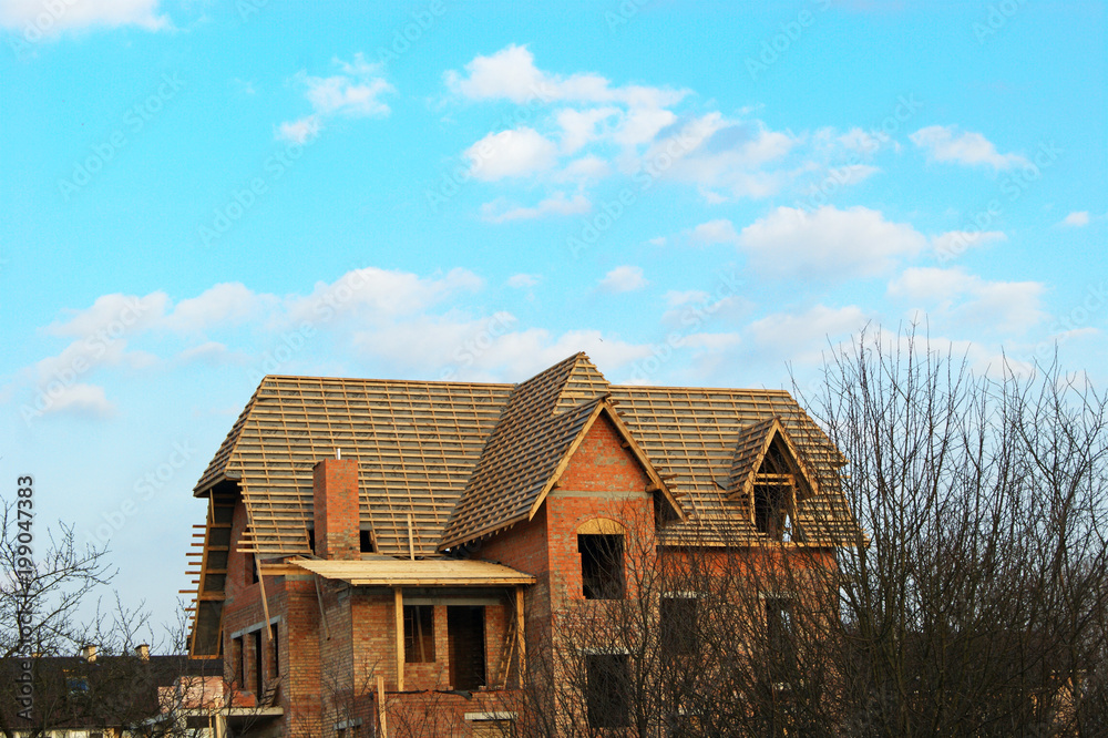 Construction of the roof of a private house, laying of beams and boards, close-up. Construction of the roof of a private house, laying of beams and boards, close-up.