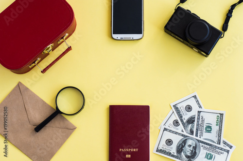 Going to travel. Map, camera, passport, magnifier, glasses, phone and money. Things for vacation. Flatlay set for traveling on yellow background. Travel abroad. Take a rest. Summer vacation.