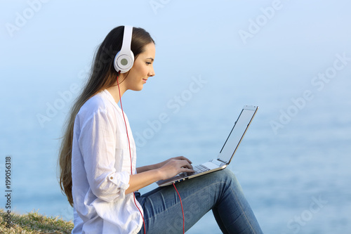 Girl learning on line with a laptop and headphones