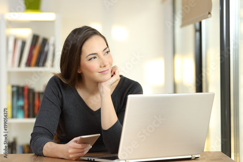 Woman dreaming using multiple devices at home