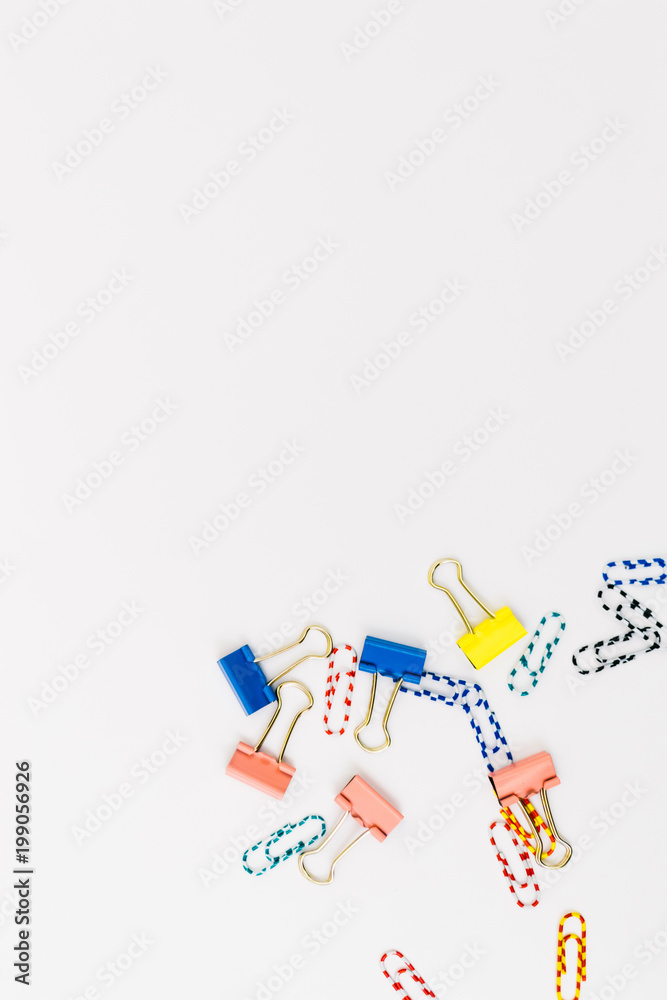 Top view of office accessories, paper clips, on white background with space for your text or photo