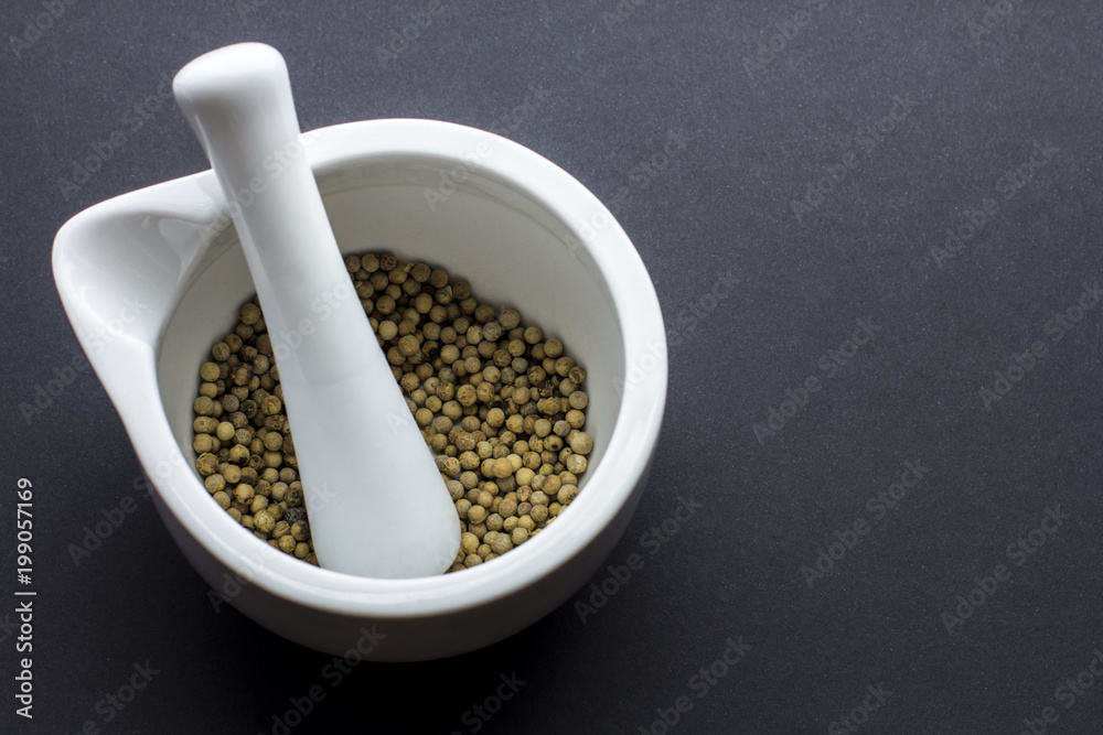 White peper peppercorns in mortar and pestle White peper peppercorns in mortar and pestle