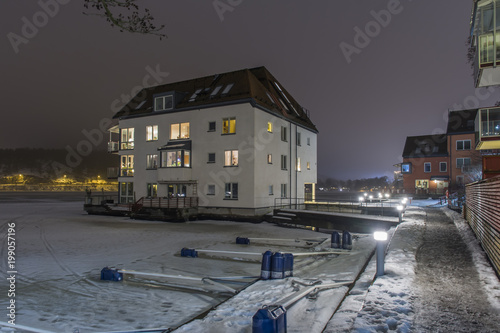 Sjönära bostadshus vid Järla sjö där vissa hus är byggda ute i vattnet, fotat en vinter natt photo