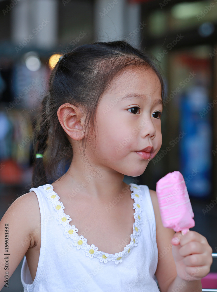 Little asian child girl eating ice-cream. Little asian child girl eating ice-cream.