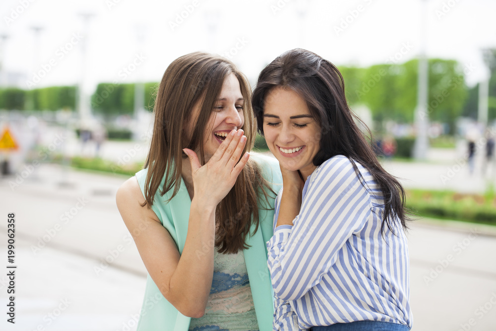 Fototapeta premium Two young women talking to each other