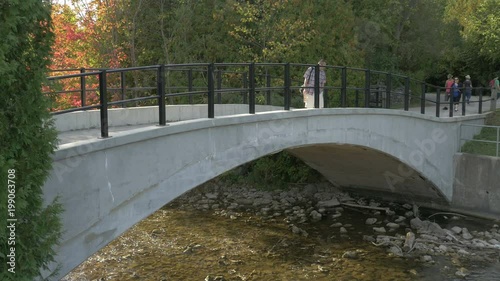 Tourists walking on a bridge photo
