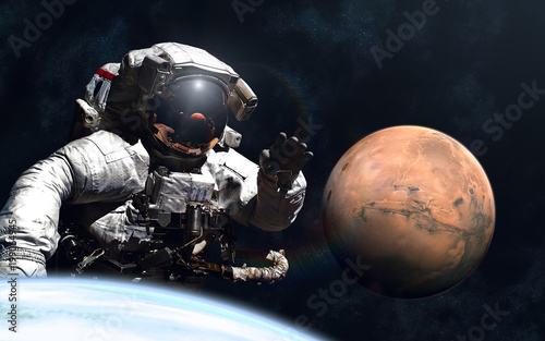 Fototapeta Naklejka Na Ścianę i Meble -  Giant astronaut and little Mars. Image in 5K resolution for desktop wallpaper. Elements of the image are furnished by NASA