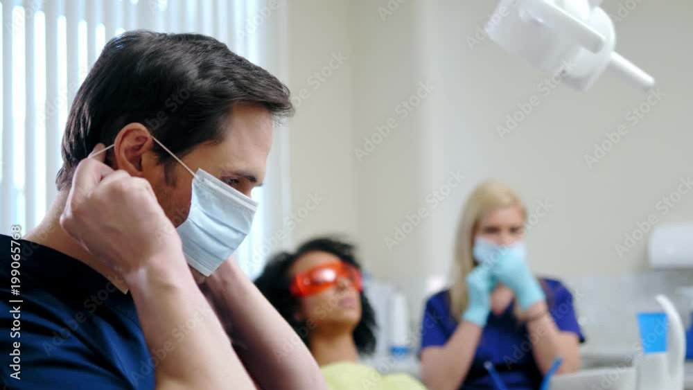 Dentist and his assitant working in private practice. Dentist and his assitant working in private practice.