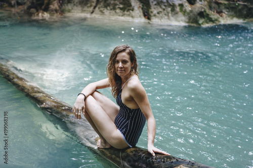 White woman enjoying the waterfall