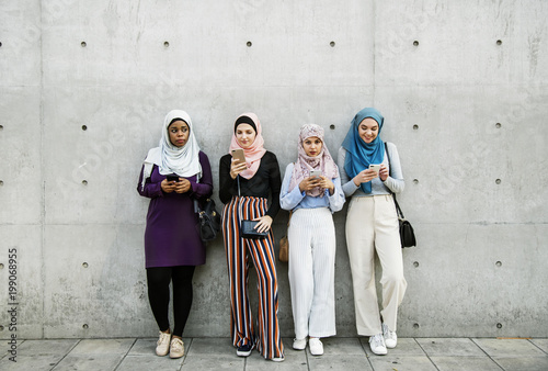 Group of muslim girls using smart phone