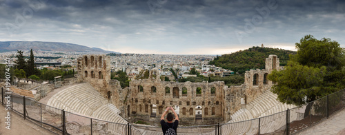 Tourist photographing Odeon of Herodes Atticus photo