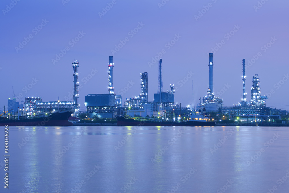 Oil refinery is near the riverside at night in Bangkok.