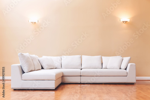 White sectional couch in a large luxury interior home