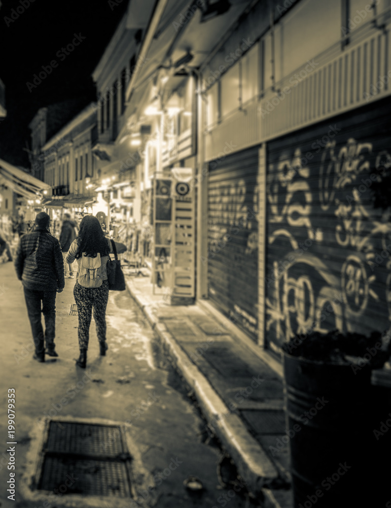 Couple walking on city street, Athens, Greece