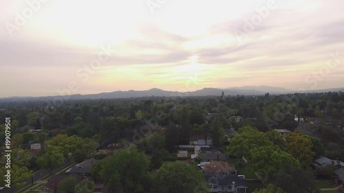 Aerial shot of neighborhood in California with mountains in the back photo