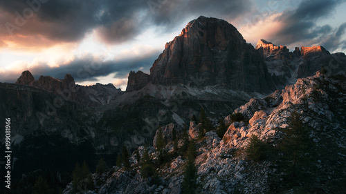 Dramatic sunset in the mountains with dark heavy clouds in Dolomite Mountains Italy